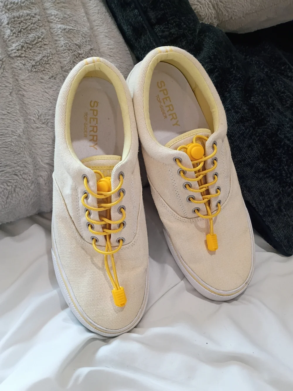 Yellow-tinged cream canvas sneakers are the Sperry Striper II CVO low-tops Sz 10